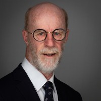 Portrait of a bearded man wearing glasses.