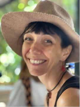 Photo of a smiling person wearing a sunhat